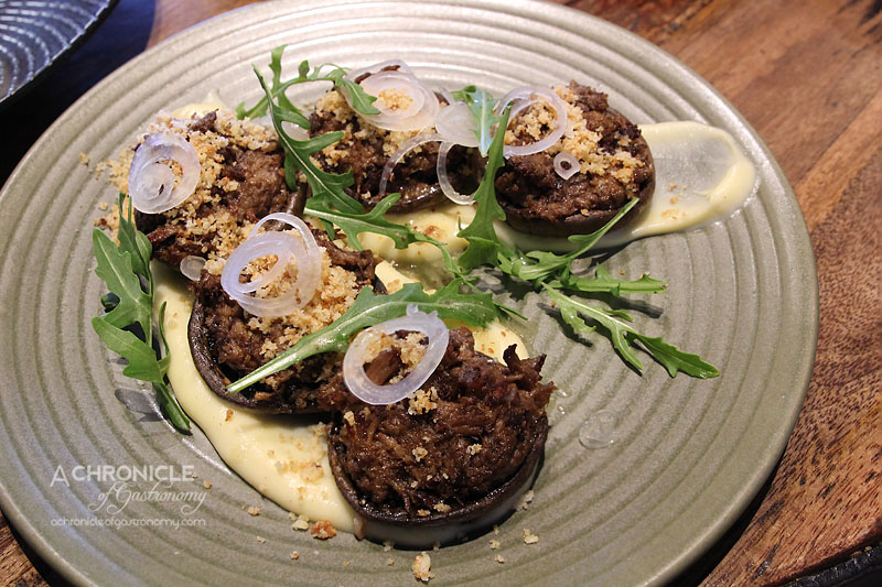 Scarvelli Cafe - Our Braised Swan Bay Beef - Slow Braised Beef Cheek, Torn and Stuffed in Baked Mushrooms, Parsnip Puree, Brioche and Herb Crumb, Pickled Onion, Leaves ($19.50)
