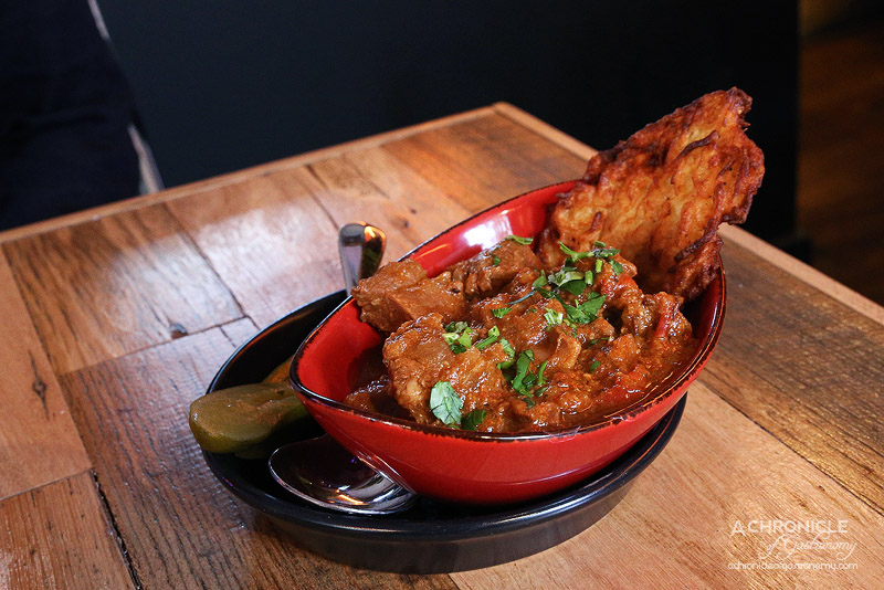 Palinka Bar & Restaurant - Hungarian Beef Goulash - 6 Hour Slow Cooked Beef Seasoned with Onion, Tomato, Capsicum, Hungarian Sweet Paprika with a Potato Latke and Pickle ($12.50)