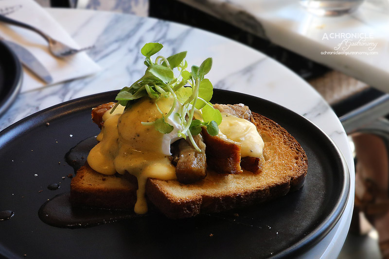 Cafe de la Ville - CDLV benedict with braised and roasted pork belly, poached eggs, toasted brioche, apple cider hollandaise, watercress salad