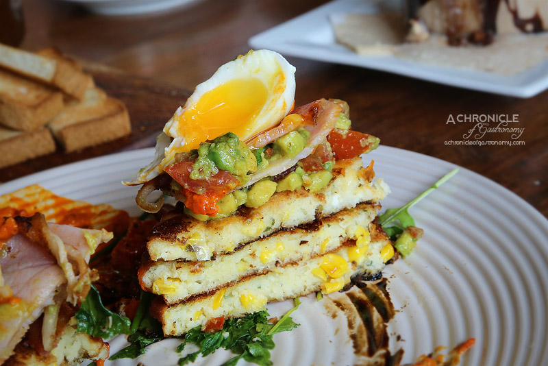 Rock Paper Scissors - Corn Fritter Stack with bacon, avocado and tomato salsa, smoked capsicum relish, poached egg, balsamic glaze ($17.50)
