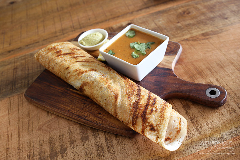 World Vegetarian Cafe - Masala dosa - Rice crepe stuffed with spiced potato and peas, side of lentil soup and coconut chutney ($13.95)