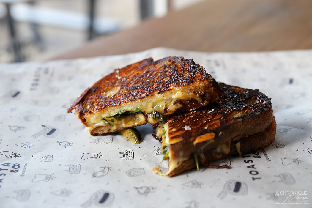 Toasta & Co - Russell - Cheese blend, bacon jam, roasted brussell sprouts + duck fat ($13+1)