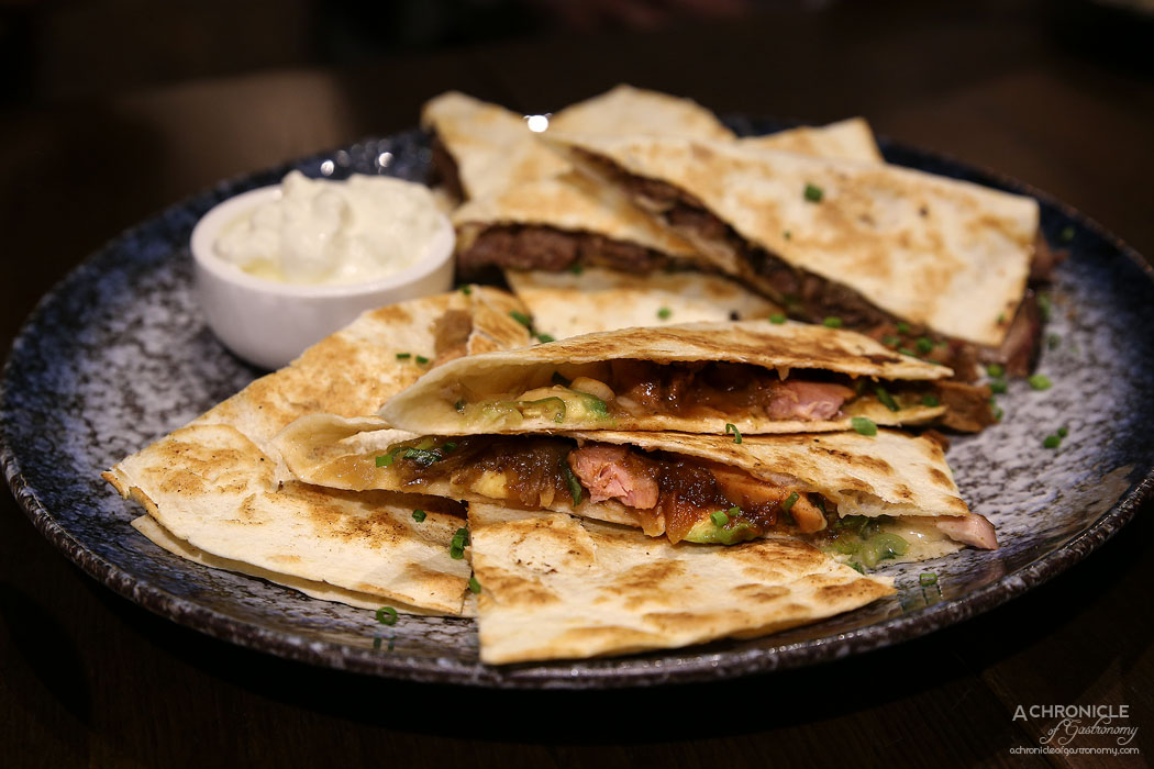 Third Wave Cafe - Pulled Chicken Quesadilla - Grilled tortilla, slow smoked & pulled chicken, Asiago cheese, chives, our house made Sweet Apple Bourbon BBQ sauce, avocado and sauteed onions