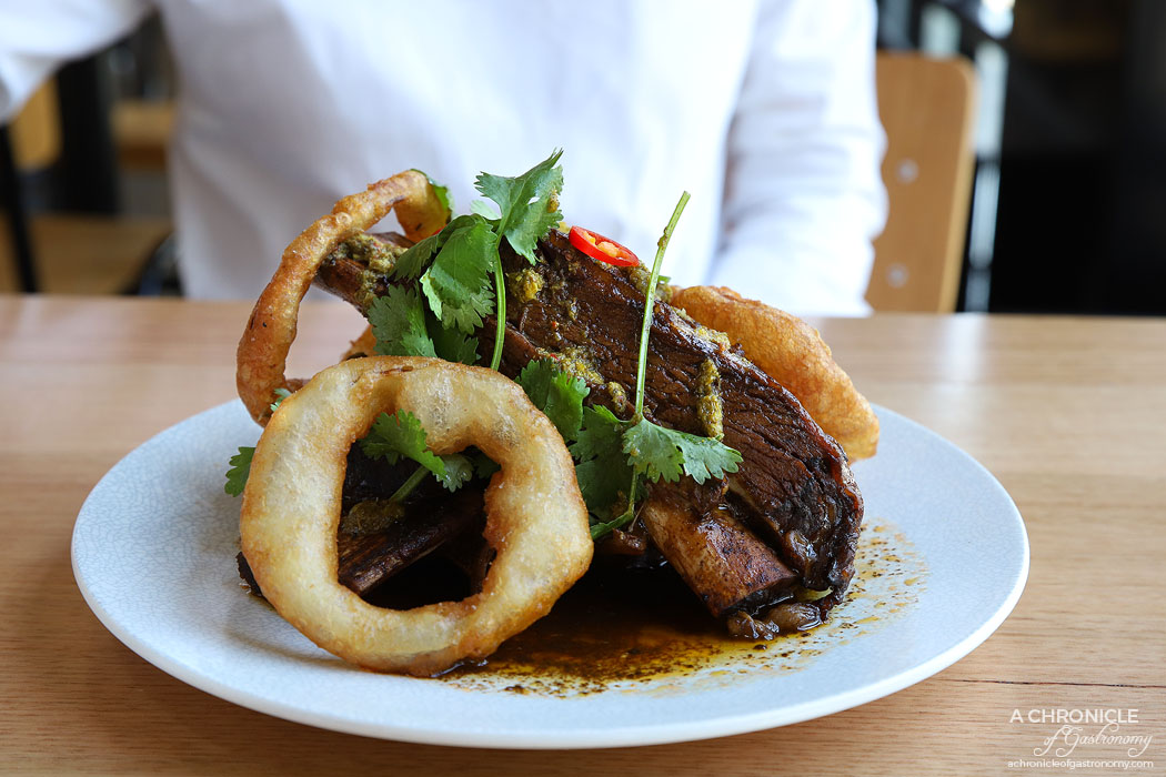 Two Fat Monks - Braised Bourbon Beef Ribs - Slow-cooked beef short ribs, onion rings, chimichurri ($24)