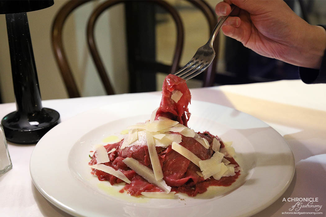 Spinetoli - Thinly sliced rare beef filet, prepared with fresh rocket salad and shavings of grana parmesan cheese ($19)