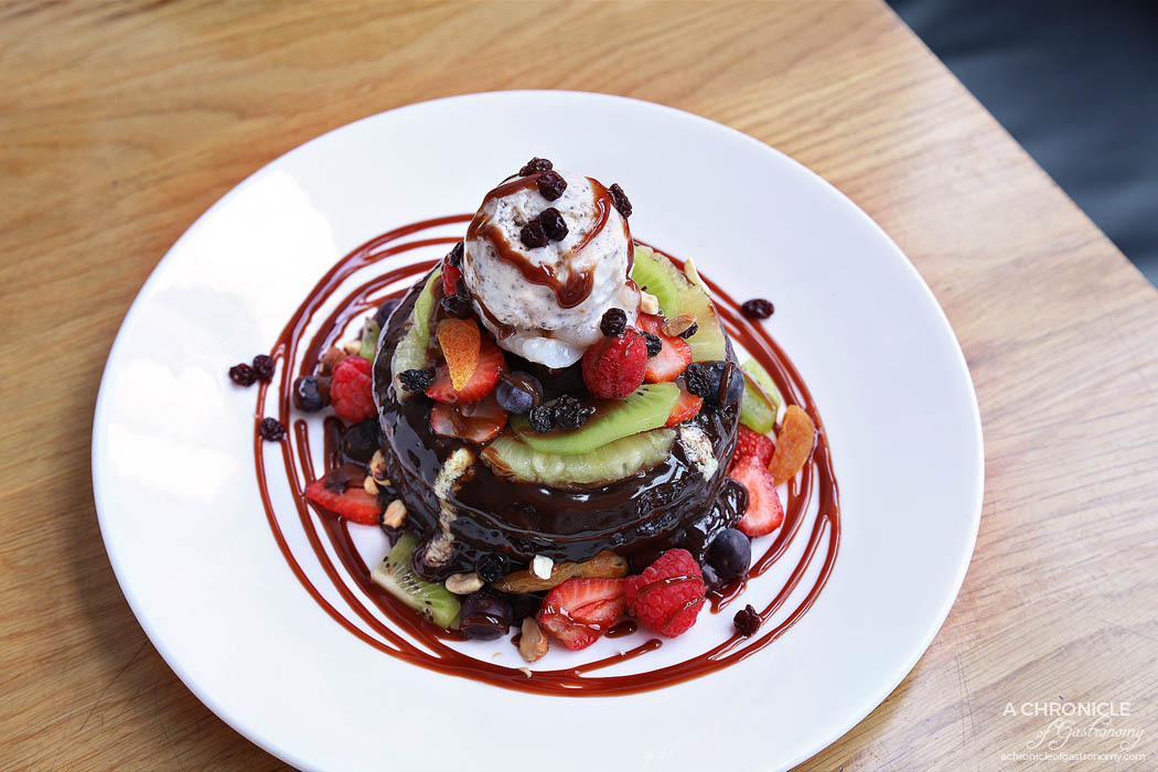 High Society - Pancake Stack - Buttermilk pancakes with poached pear, mascarpone, nuts, vanilla ice cream, fresh fruits, coverture chocolate sauce ($19)