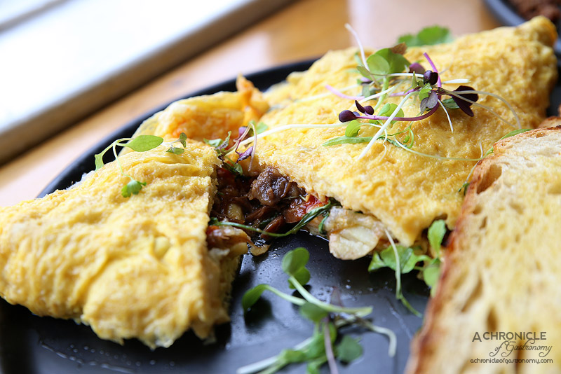 Uncle Drew - Omelette with sichuan pepper and cider braised pork hock, kipfler potatoes, manchego, coriander, sambal oelek and sourdough toast ($17)