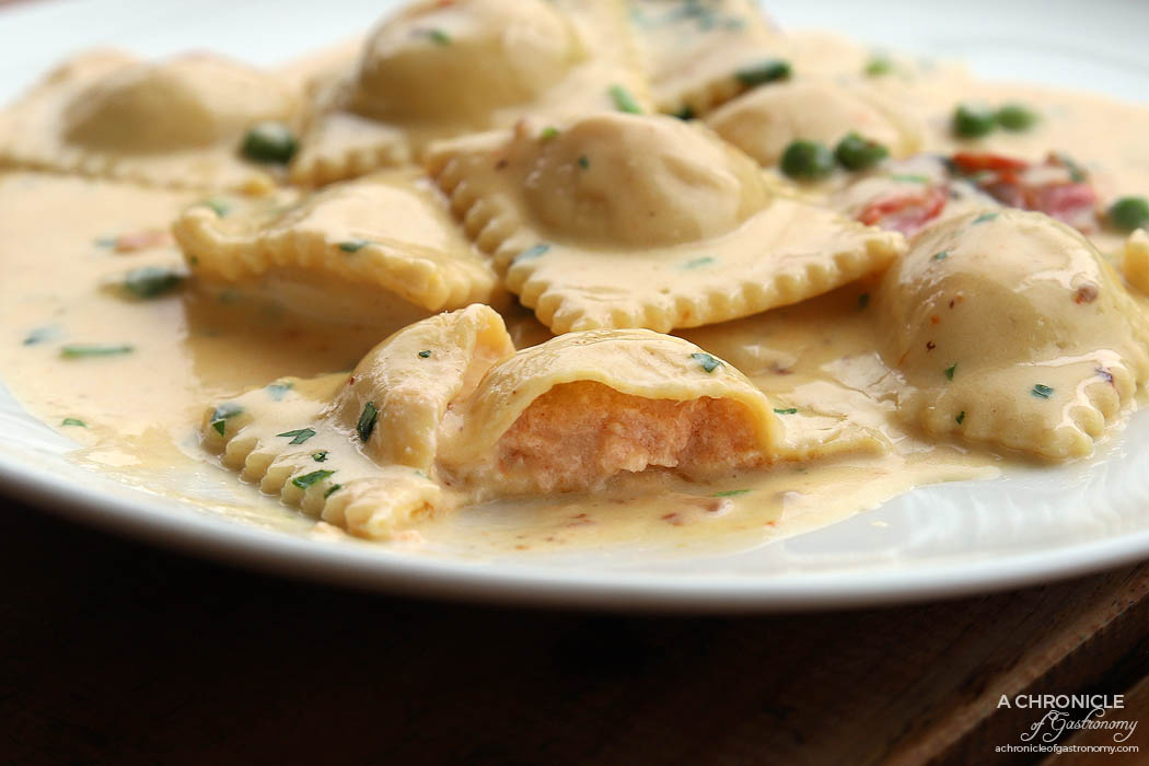 Shop 225 - Homemade Ravioli - Fresh pasta filled with salmon and mascarpone, served with a creamy, green peas and roasted tomato sauce ($25)